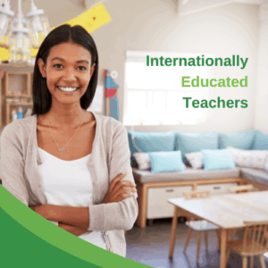Smiling female teacher in a classroom with a table and chairs at the back